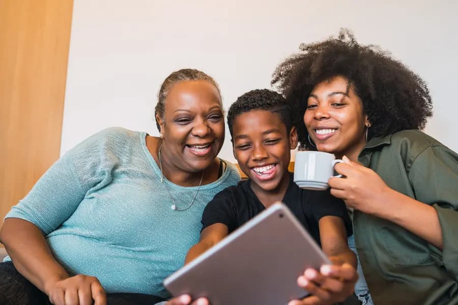 A family video calling relatives together on a tablet