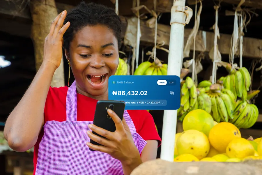 A market trader checking her NGN balance on her phone